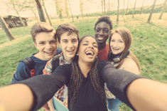 stock-photo-58978862-group-of-multiethnic-teenagers-taking-a-selfie-at-park